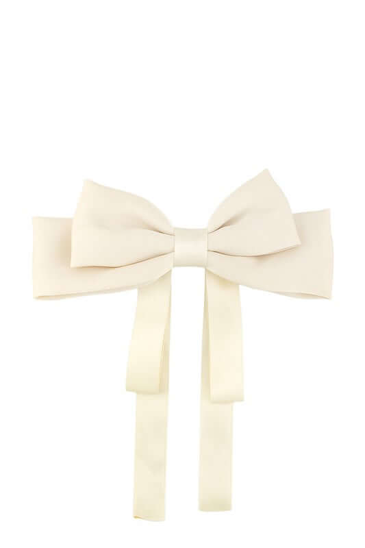 Large cream hair bow with long ribbon tails for stylish hair accessories and beauty looks.