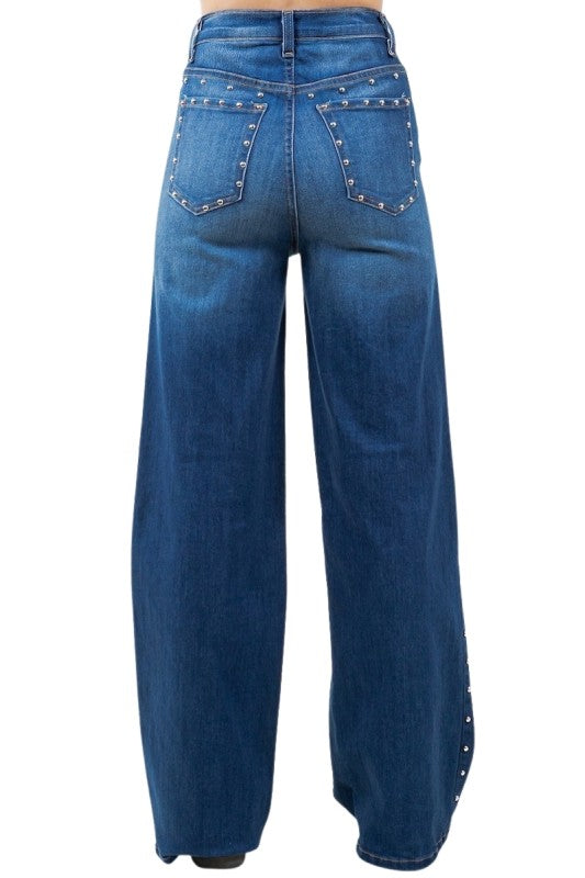 Blue jeans with decorative studs on a white background