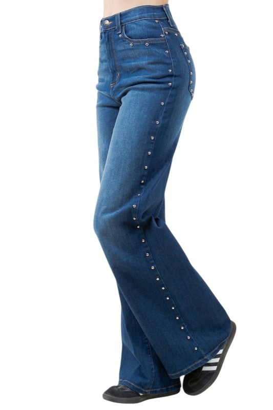 Blue jeans with decorative studs on a white background