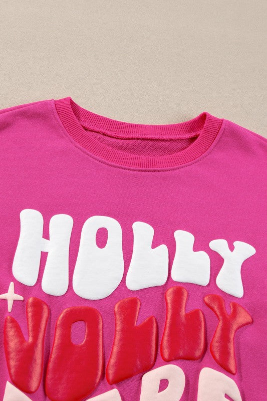 Pink sweatshirt with white and red text on a beige background