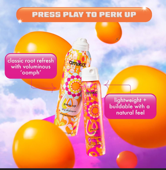 Amika dry shampoo bottles with colorful design against a bright, abstract background