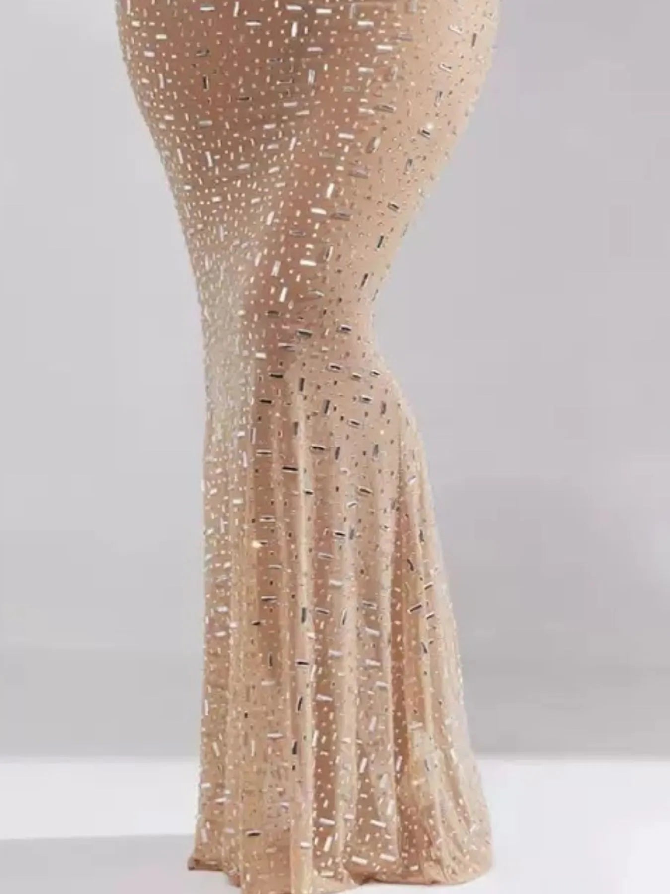 Gold sequin tablecloth on a white background