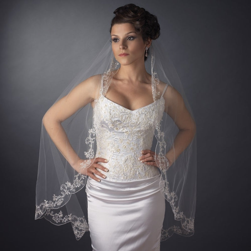 Bridal model showcasing a single-layer waltz-length veil with couture embroidery, complementing a stunning wedding gown.