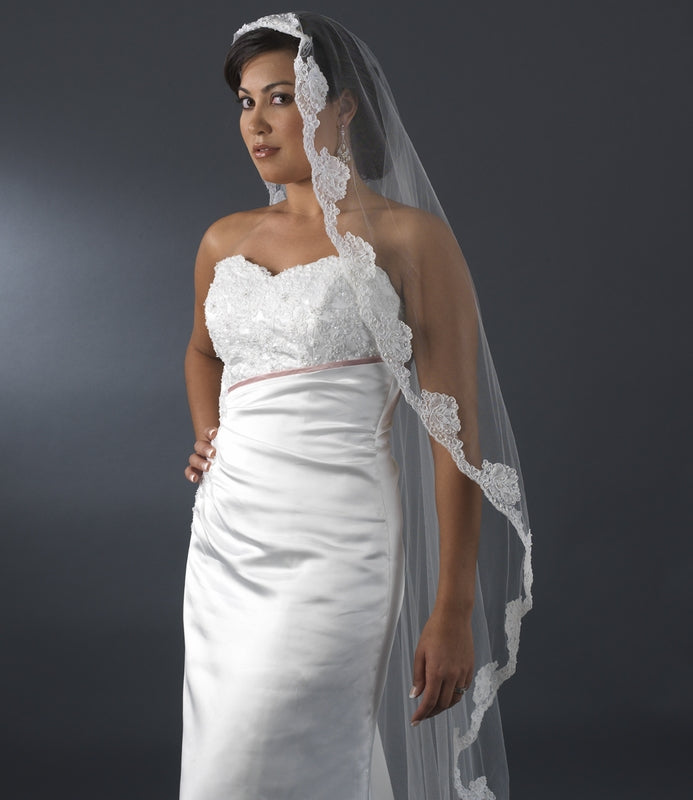 Bride wearing a single layer waltz cathedral veil with floral pearl embroidery, showcasing elegance for modern and vintage weddings.