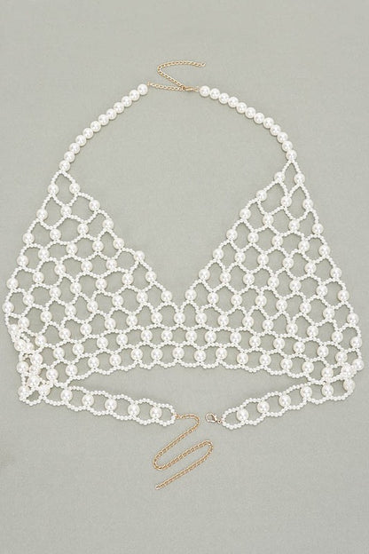 Faux Pearl Crochet Braided HalteUpgrade your summer style with our Faux Pearl Crochet Braided Halter Top. The intricate braided detailing adds a touch of elegance, while the faux pearl embellishments elevate the look. Perfect for any occasion, this crop top will make you stand out with its unique style