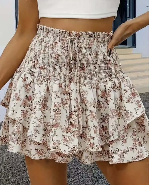 This Floral smocked mini skirt is the ultimate spring and summer essential for any trendy and chic wardrobe. The delicate floral pattern and smocked waistband add a touch of femininity and style to any outfit. Elevate your look with this must-have statement piece!
