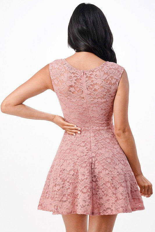 Back view of a short pink lace formal dress suitable for homecoming, featuring a fit and flare silhouette.
