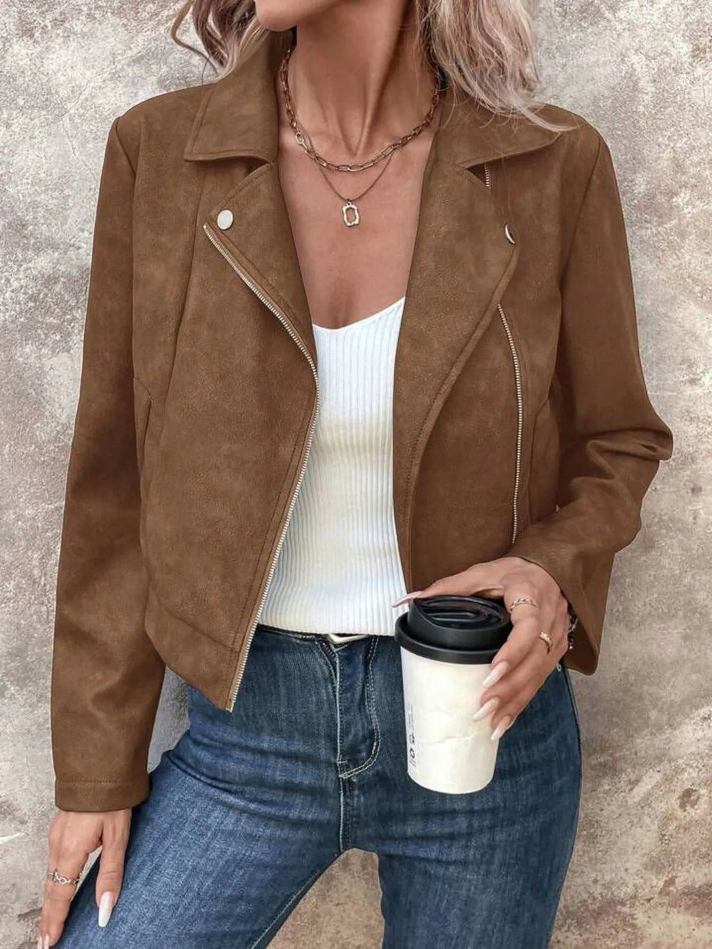 Women's Zip Up Suede Cropped Moto Jacket worn with a white top and holding a coffee, styled for fall.