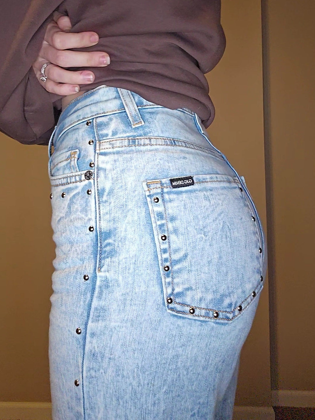 Brooklyn Studded BootCut High Rise Jeans showcasing studded detail and light wash denim in a stylish fit.