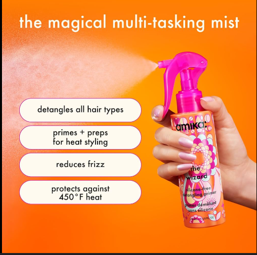 Amika hair mist spray bottle held by a hand with product features listed on an orange background