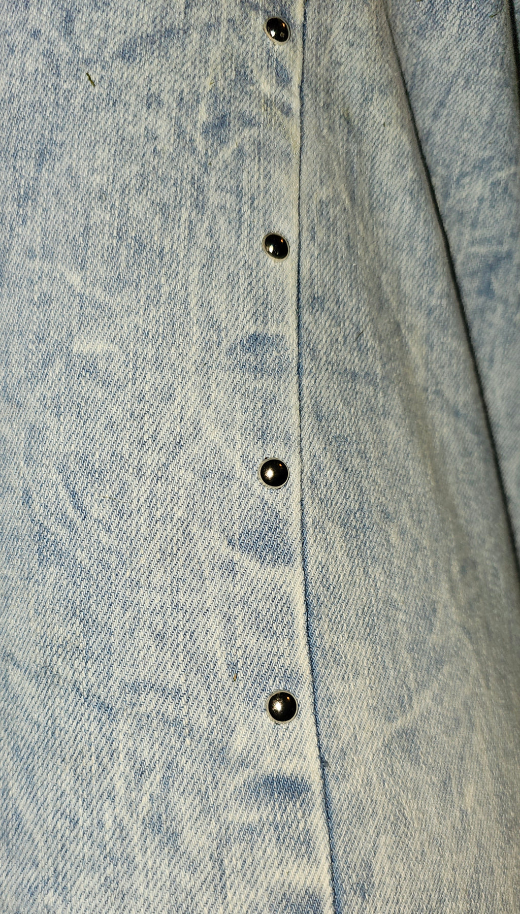 Close-up of buttons on Brooklyn Studded BootCut High Rise Jeans showcasing the light wash denim and studded detail.