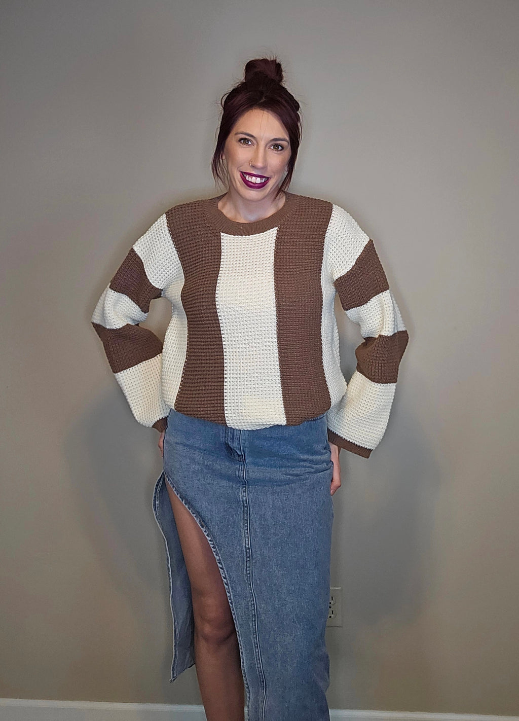 Model wearing a thigh slit denim skirt paired with a stylish sweater.