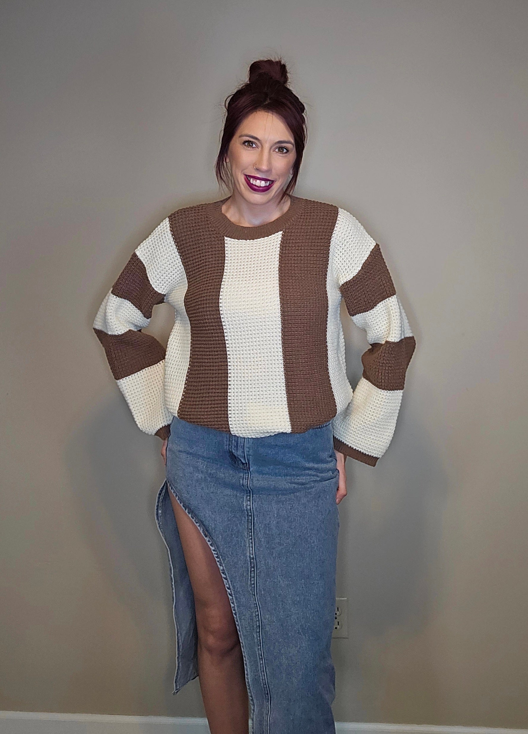 Model wearing a thigh slit denim skirt paired with a stylish sweater.