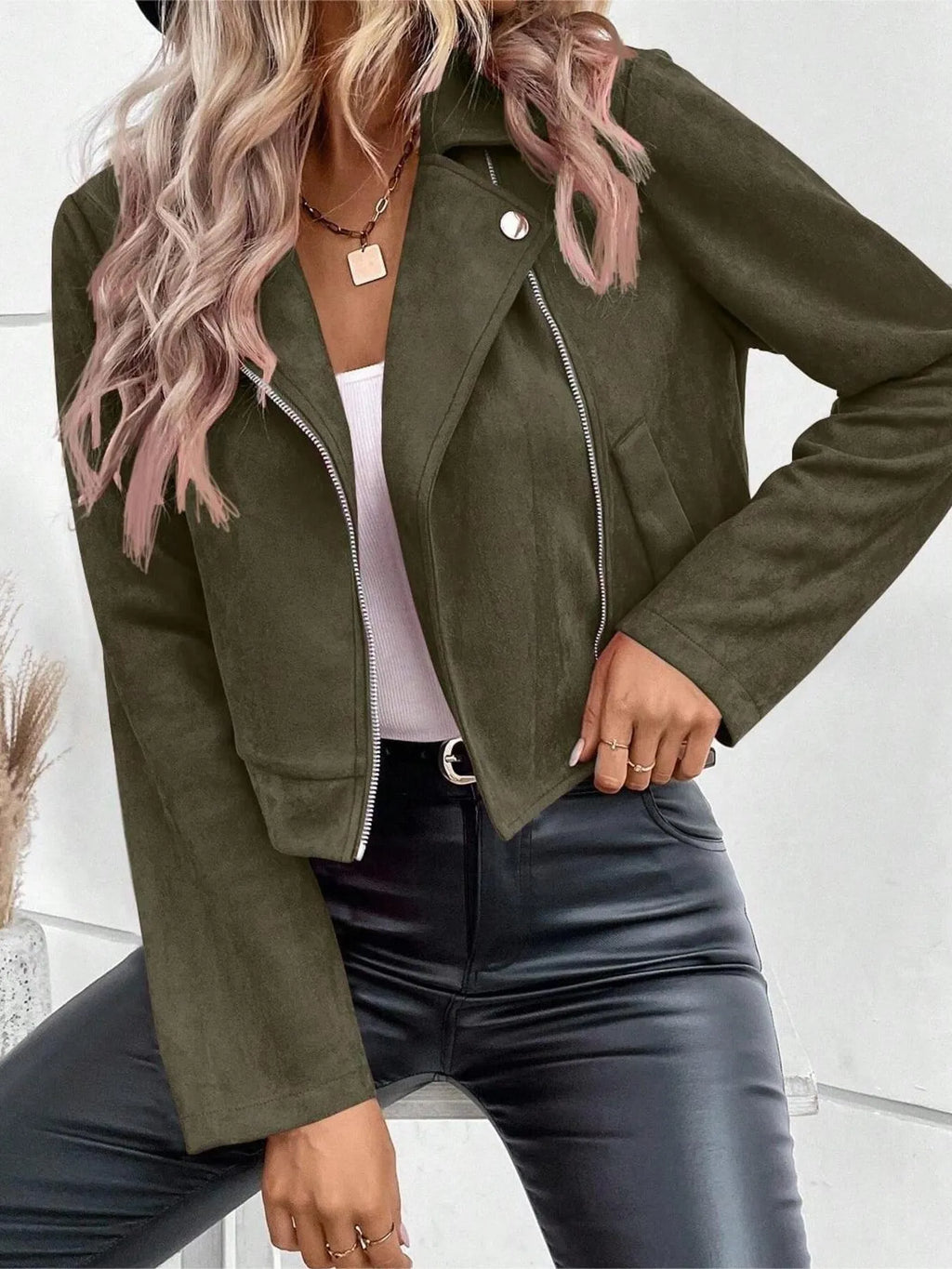 Person wearing a green jacket with a white background