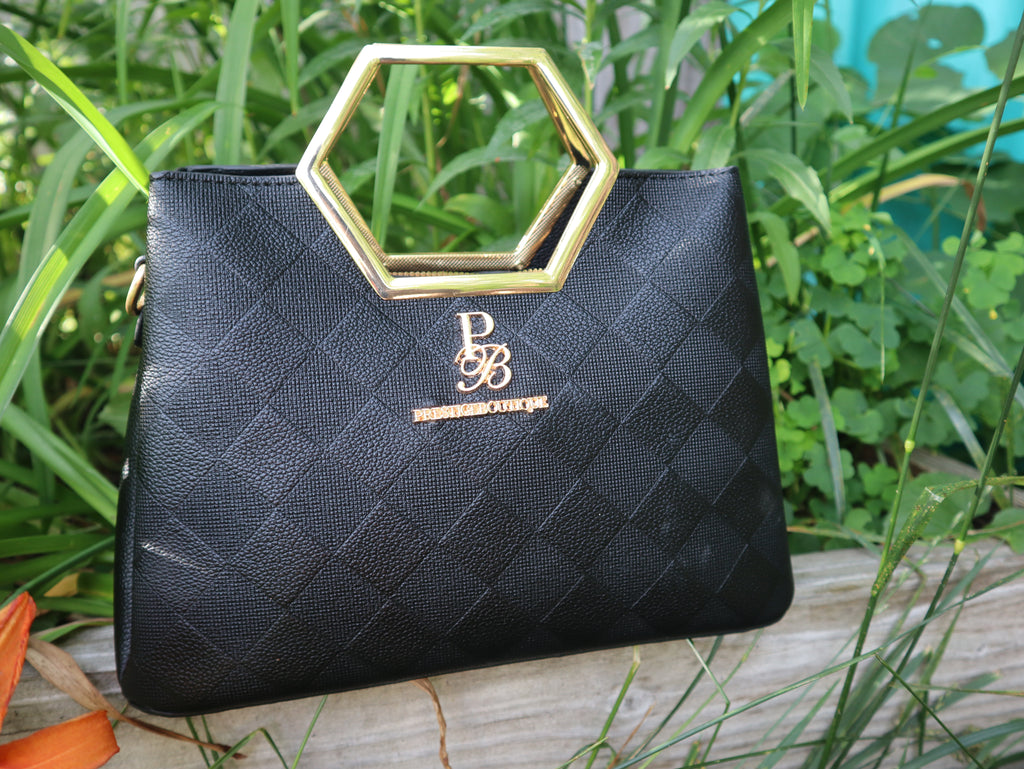 Make a fearless statement with The Hex Appeal Prestige Boutique Crossbody Handbag. This daring accessory combines high-end sophistication with practical design. Its large capacity and secure zipper keep your essentials safe while making a bold statement wherever you go. Perfect for those who refuse to blend in. Black Handbag. Gold and Black crossbody purse