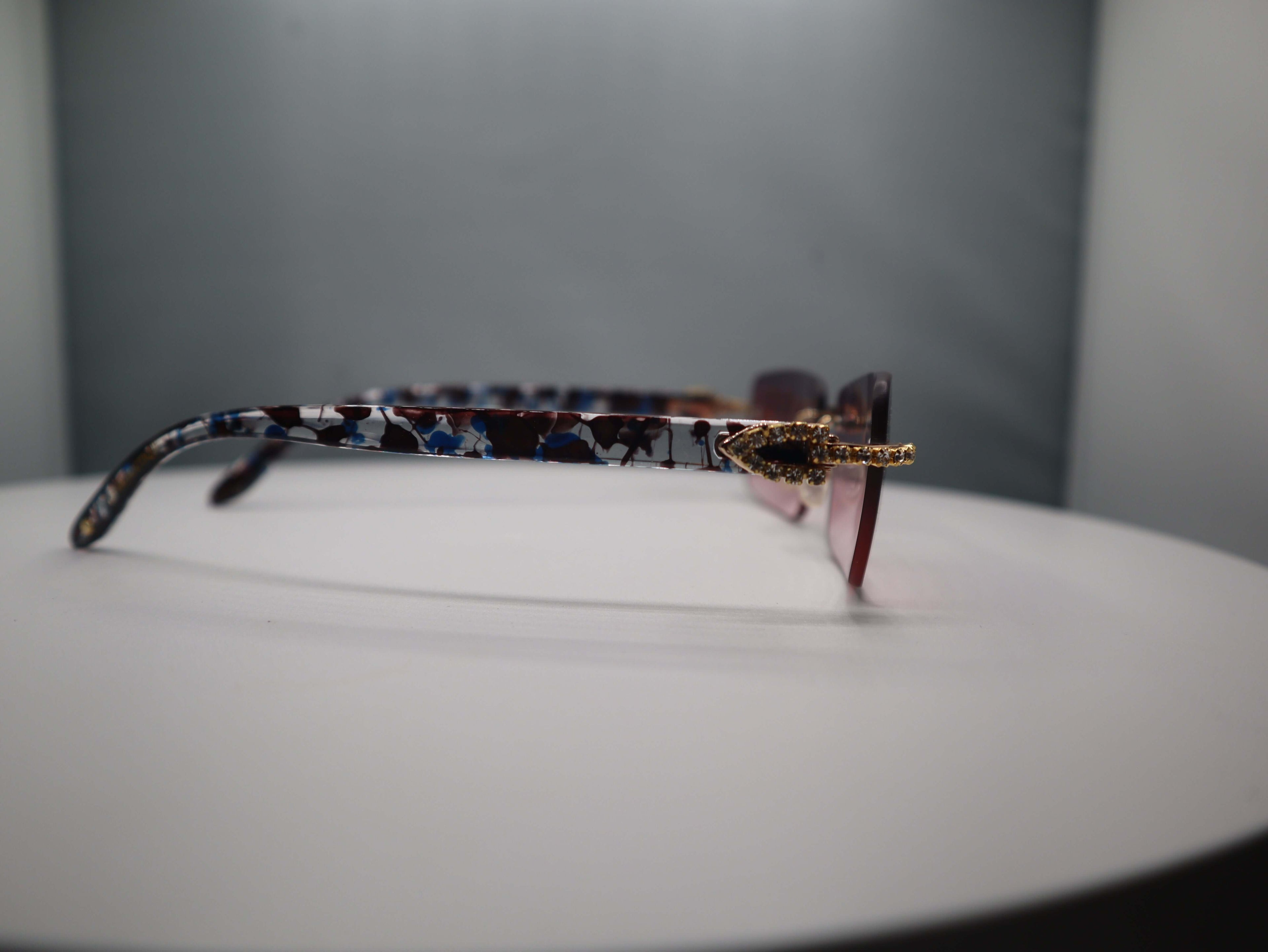 Side view of Prestige Boutique Pink Floral Sunglasses showcasing stylish pattern and decorative details.