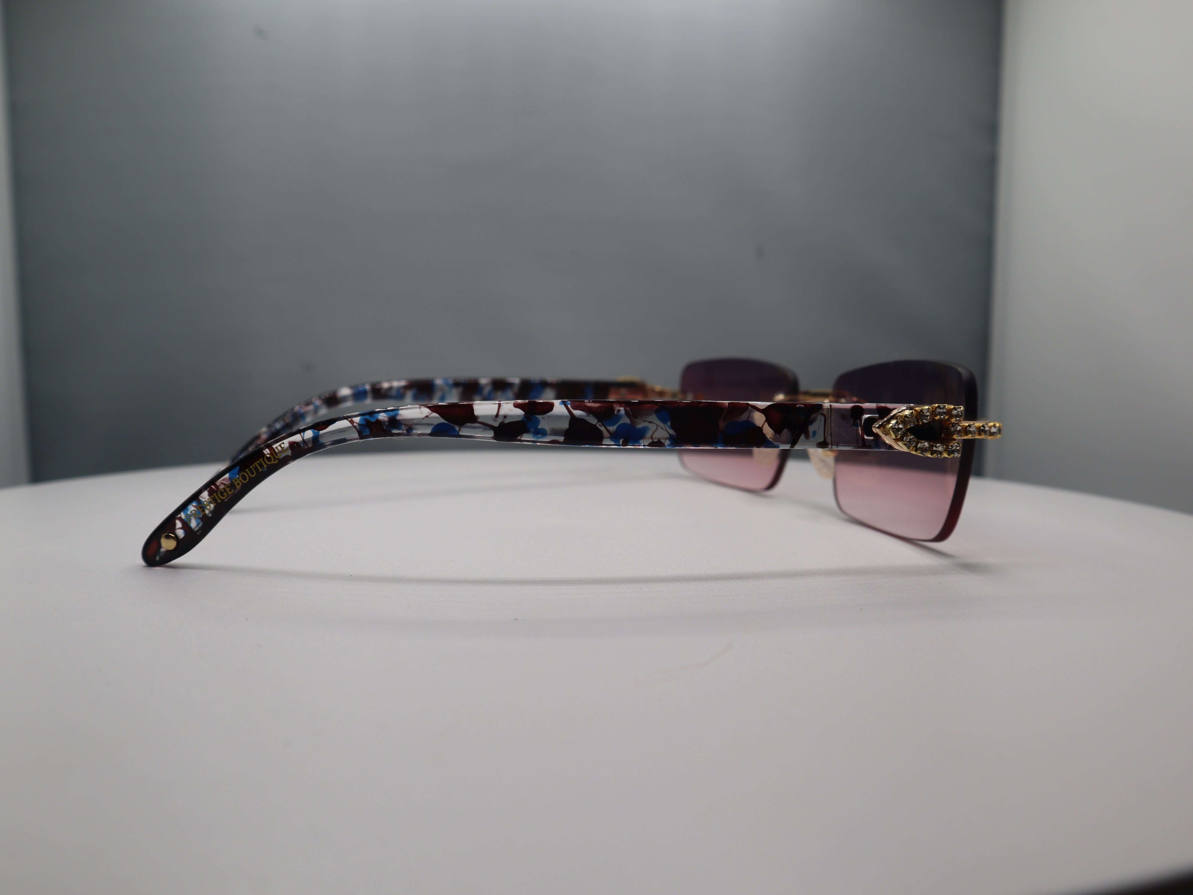 Prestige Boutique pink floral sunglasses showcasing stylish design and feminine glamour from the Hidden Gems Collection.