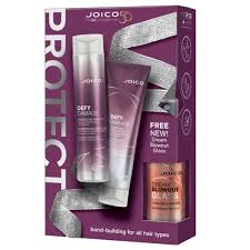 Joico hair care product set with bottles and packaging on a purple background