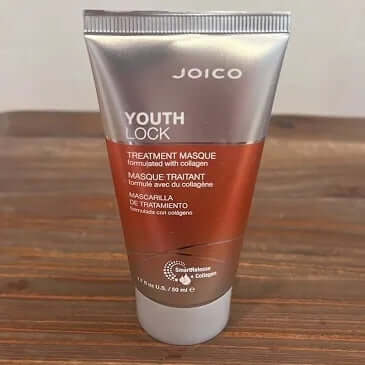 Joico Youth Lock treatment masque tube on a wooden surface