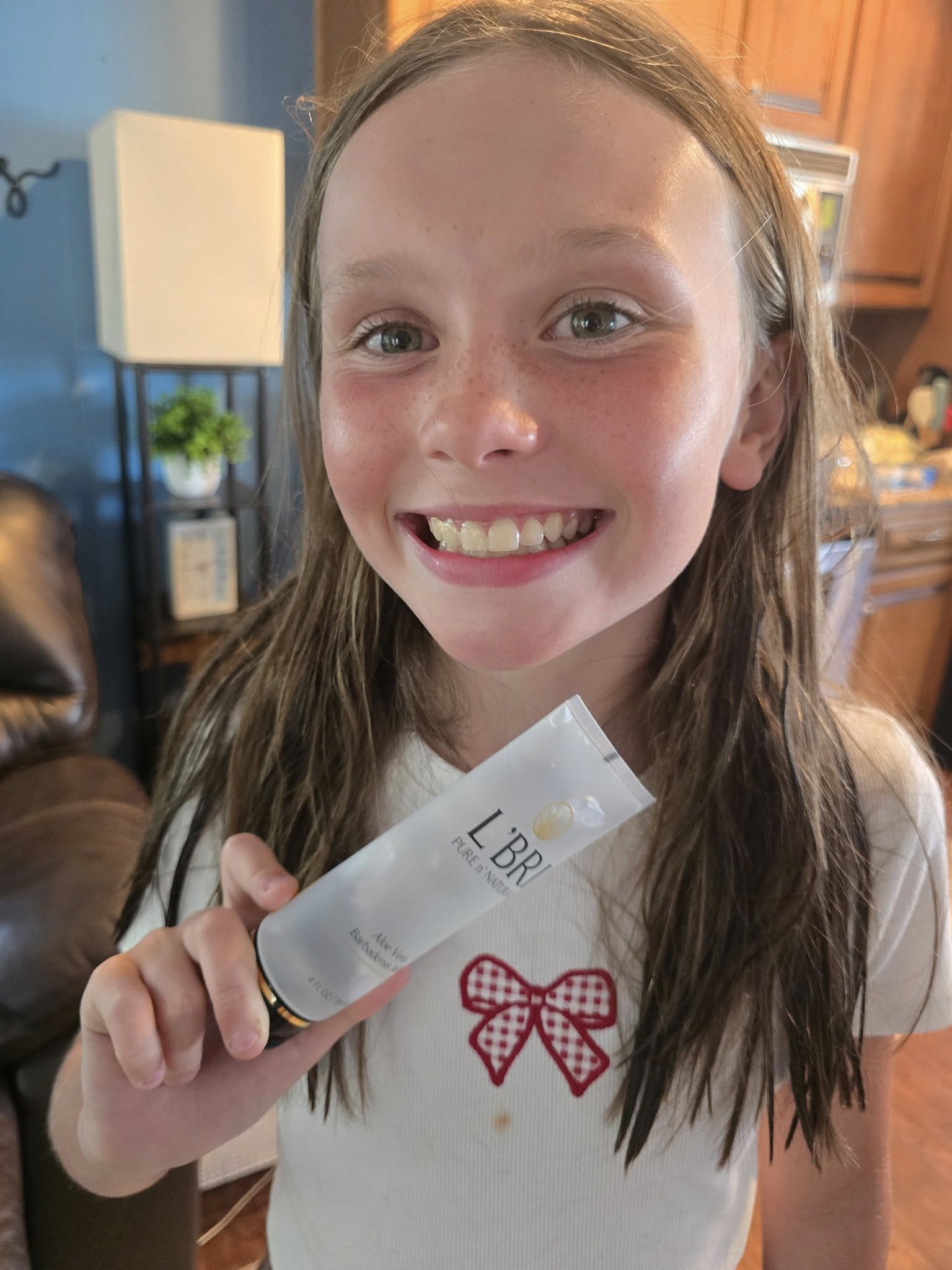 Young girl holding a product with 'LBR' aloe