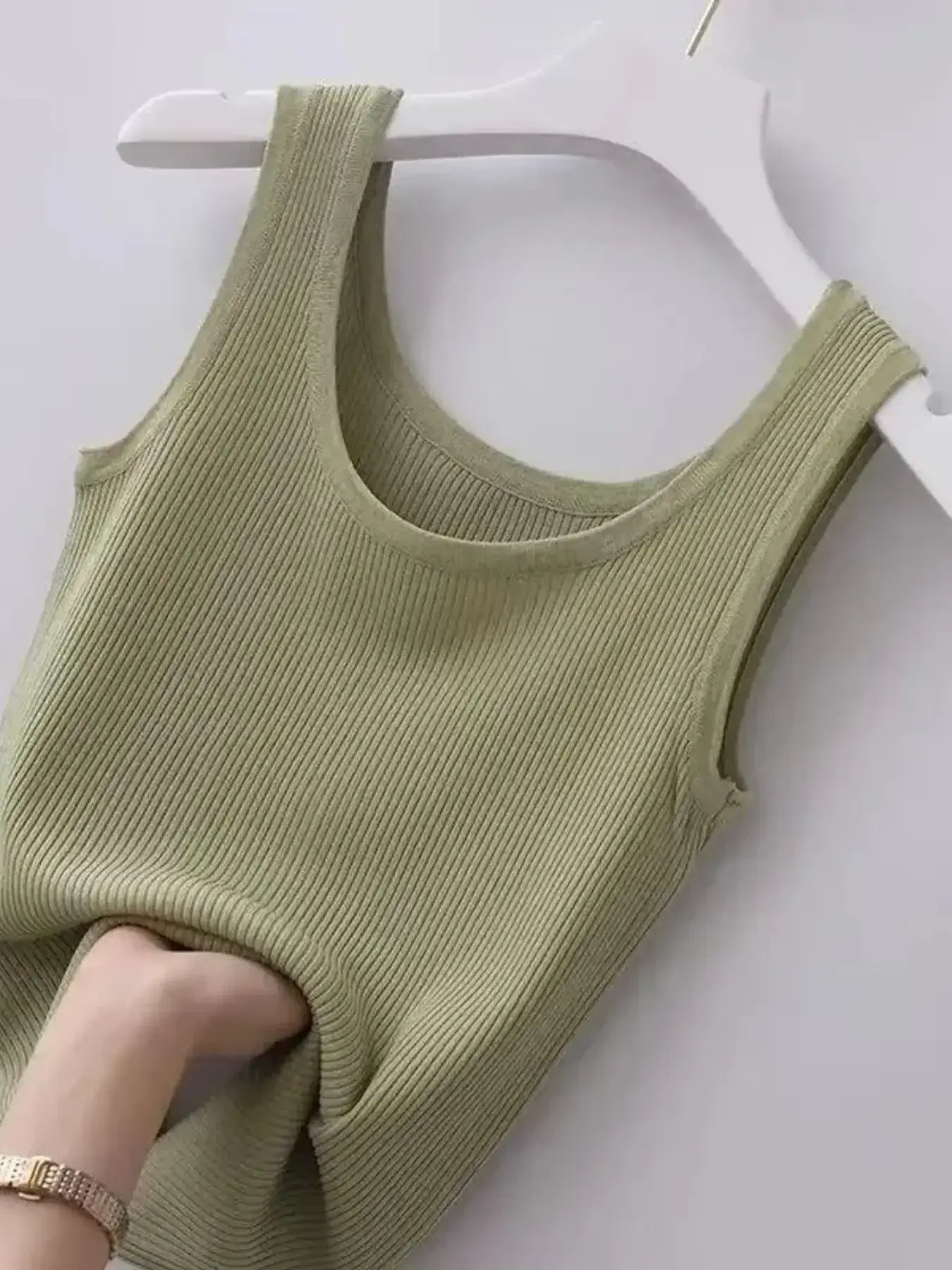 Green ribbed tank top on a white hanger
