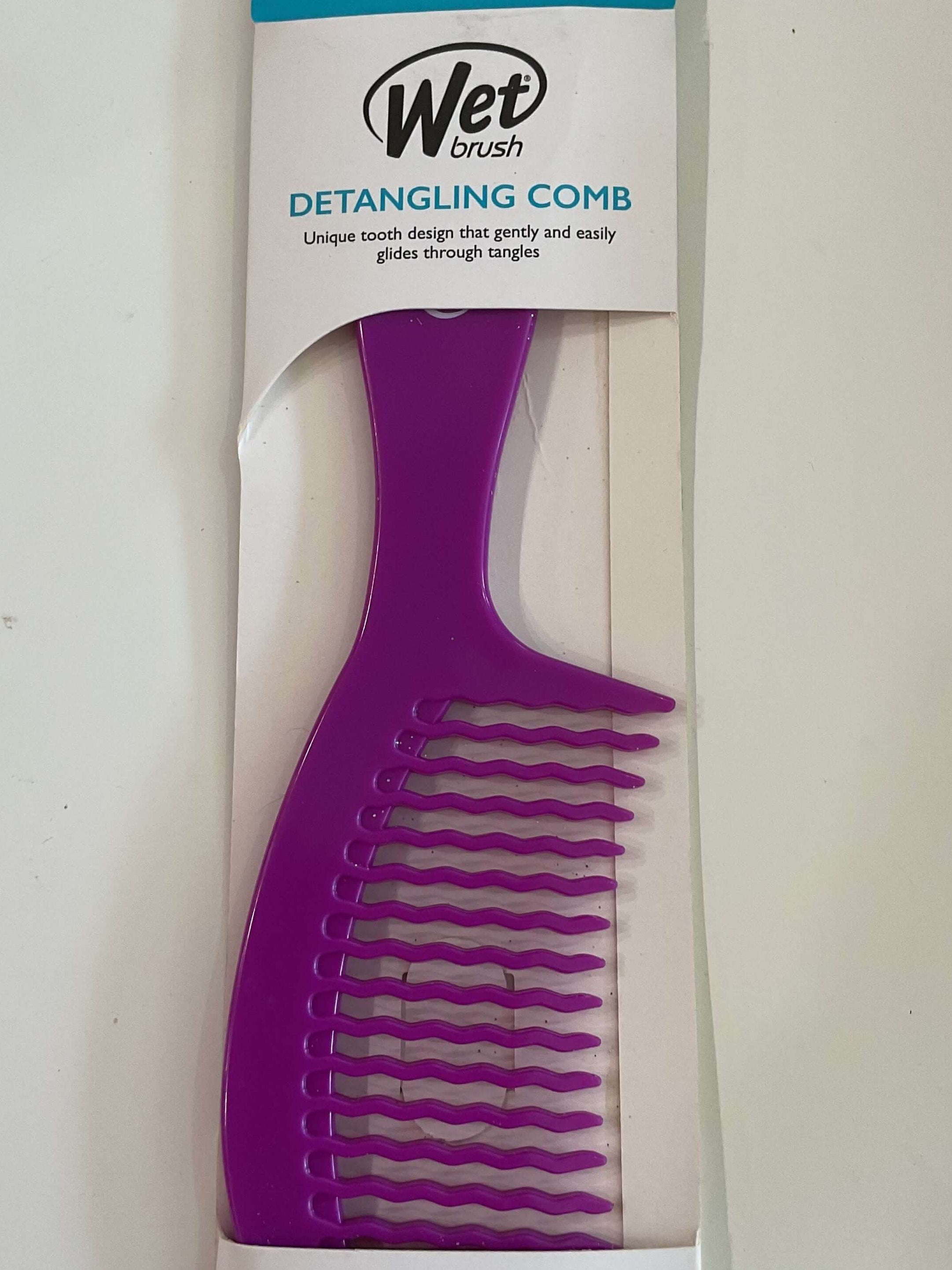 Purple detangling comb with Wet Brush packaging on a white background