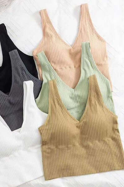 Collection of ribbed tank tops in various colors on a white background