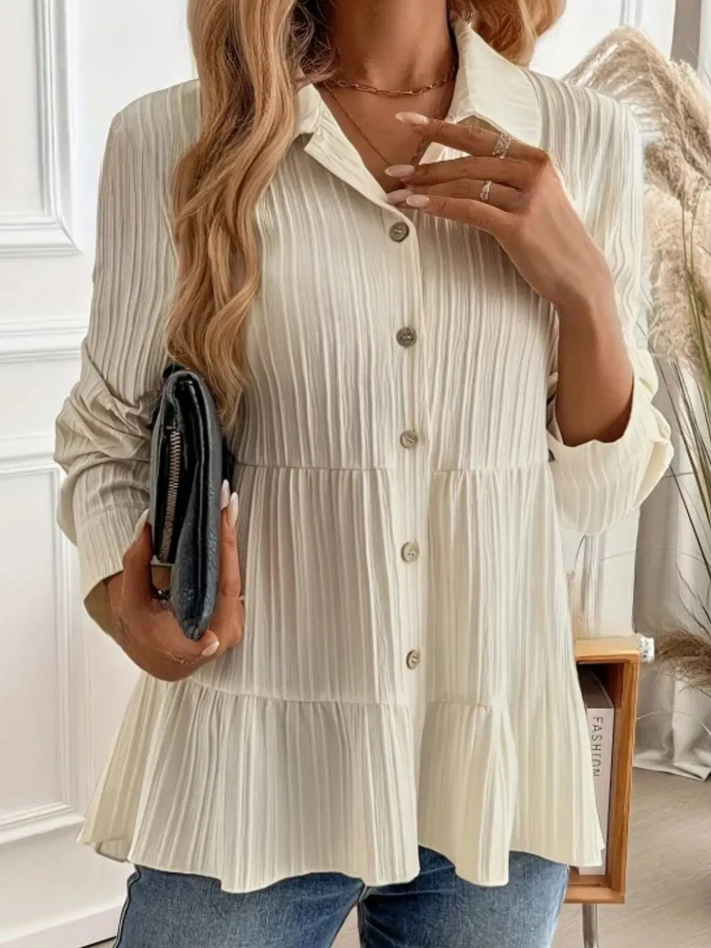 Woman wearing a white tiered blouse with a blurred indoor background