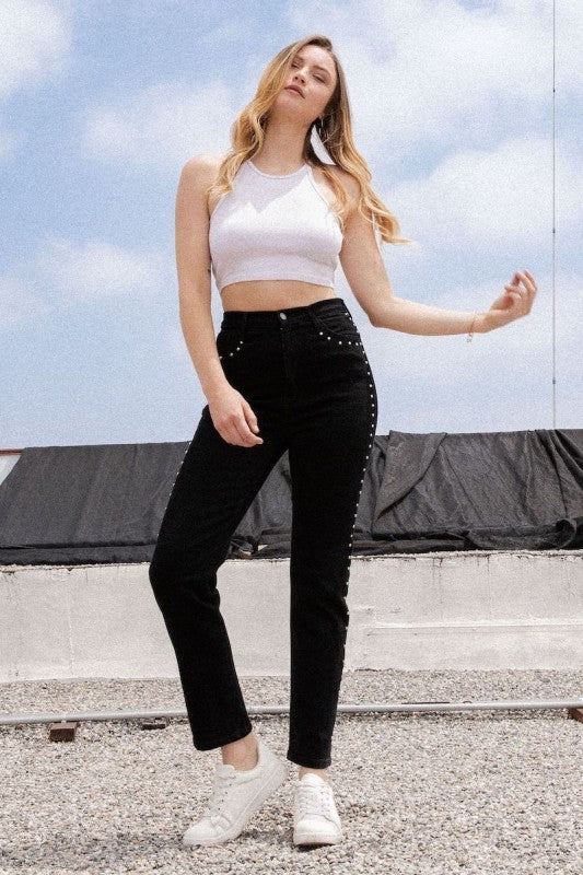 Model wearing Studded Mom Jean in Black Denim with stylish white crop top and sneakers.