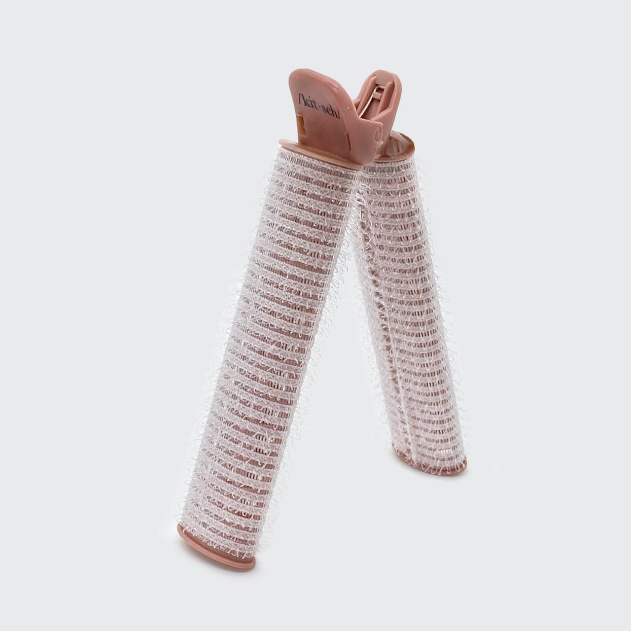 Pair of baby leg warmers with brown accents on a light gray background