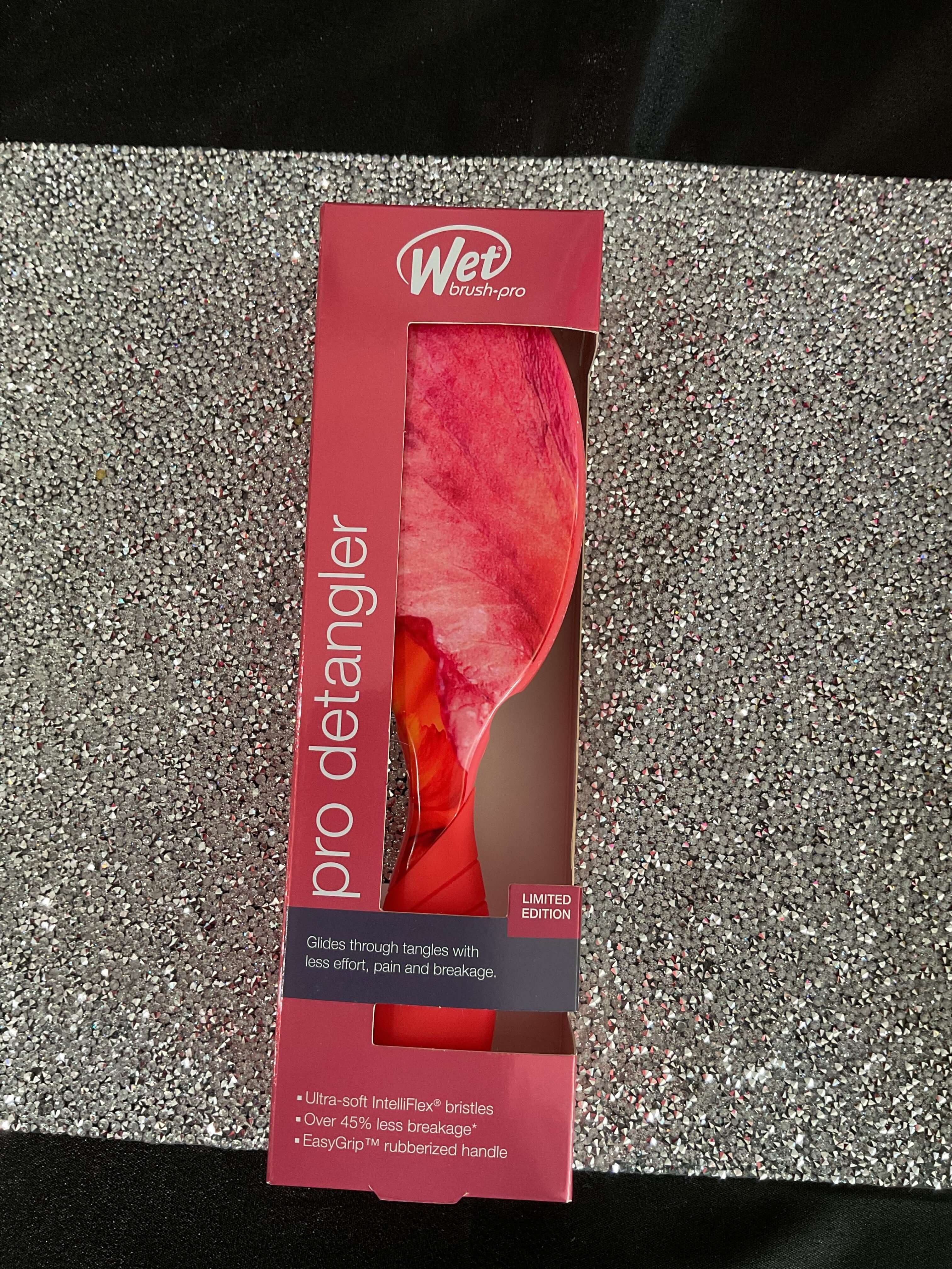 Wet brush pro detangler packaging on a glittery surface
