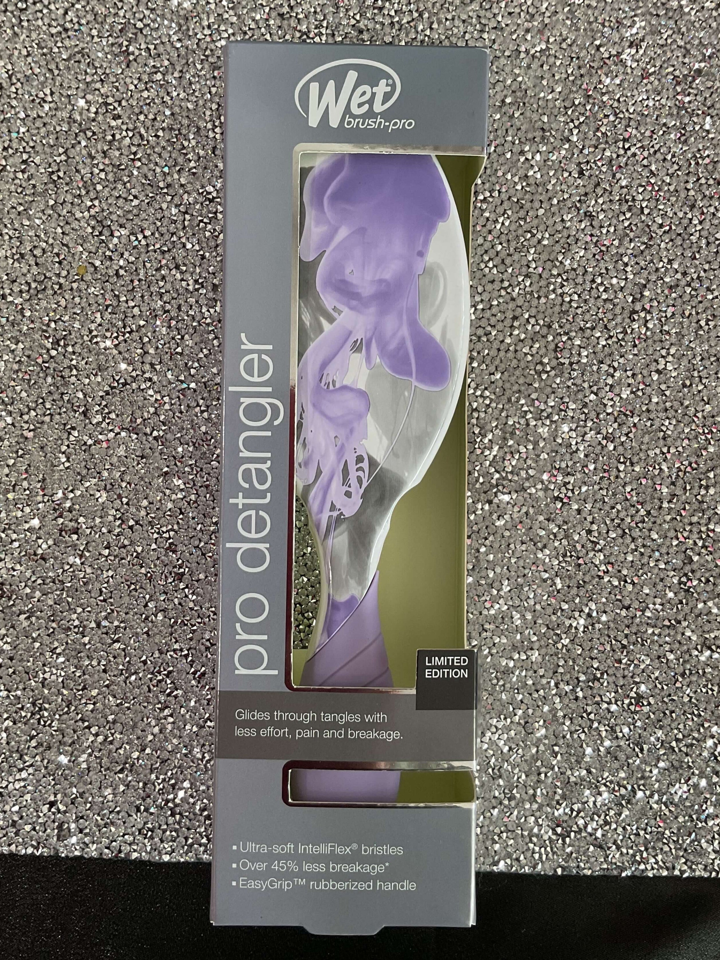 Wet brush pro detangler packaging on a glittery surface