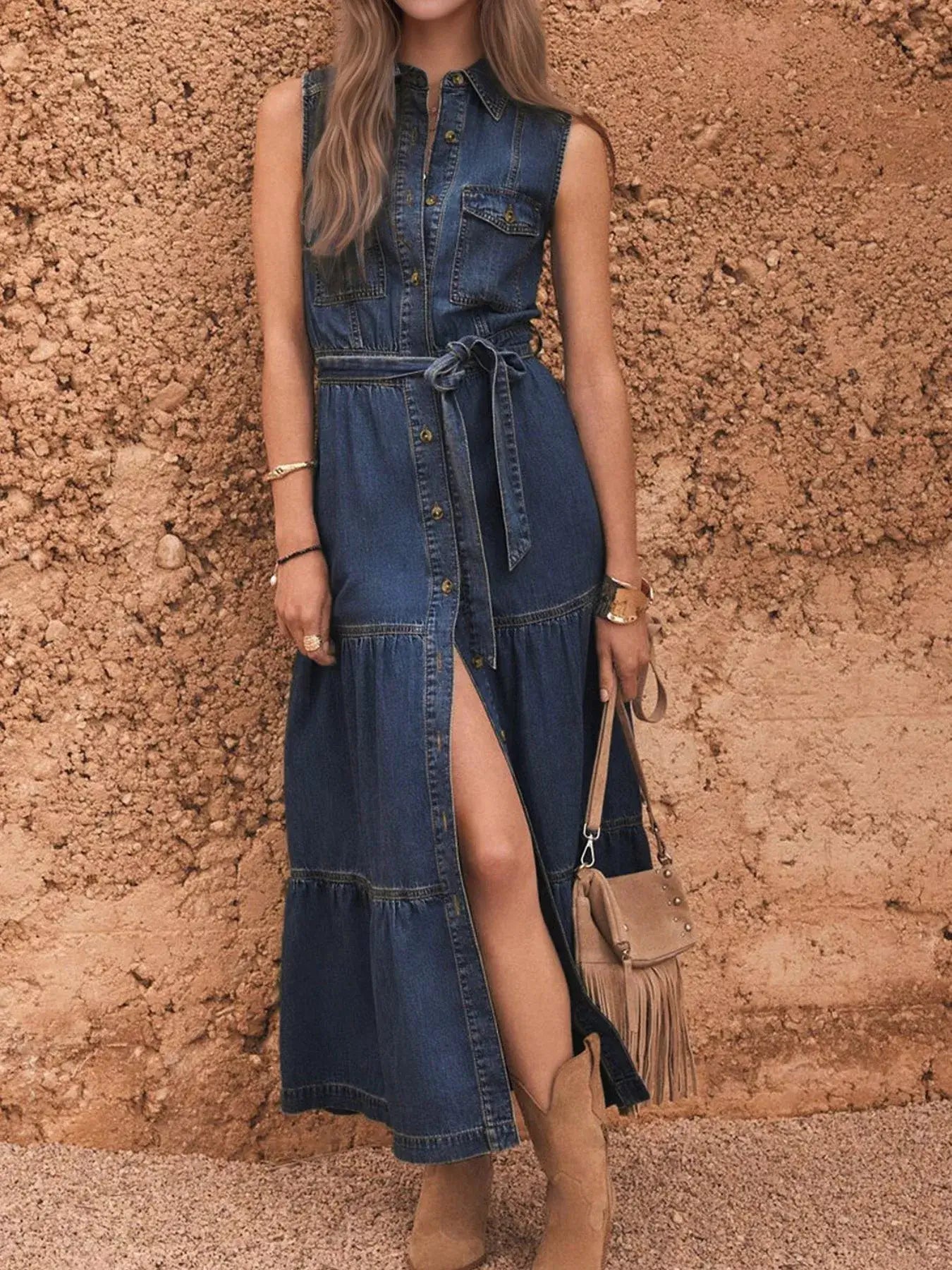 Woman wearing a denim dress with a stone wall background