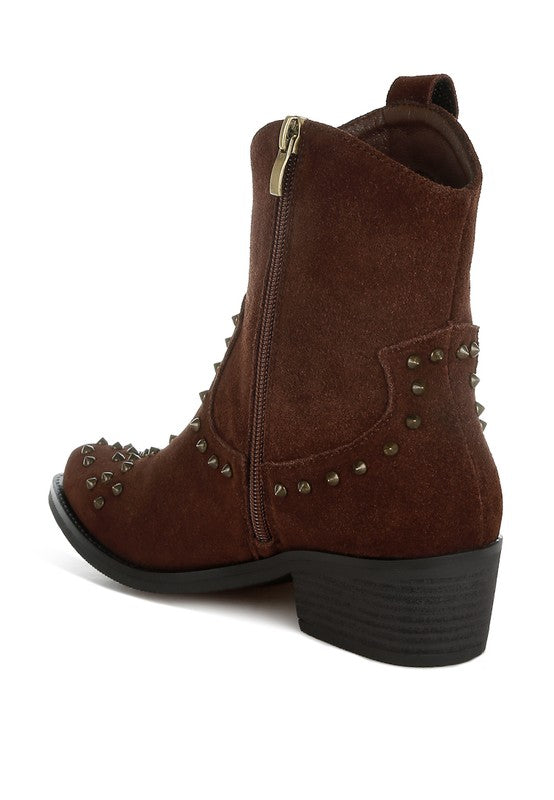 Brown suede boot with studded details on a white background