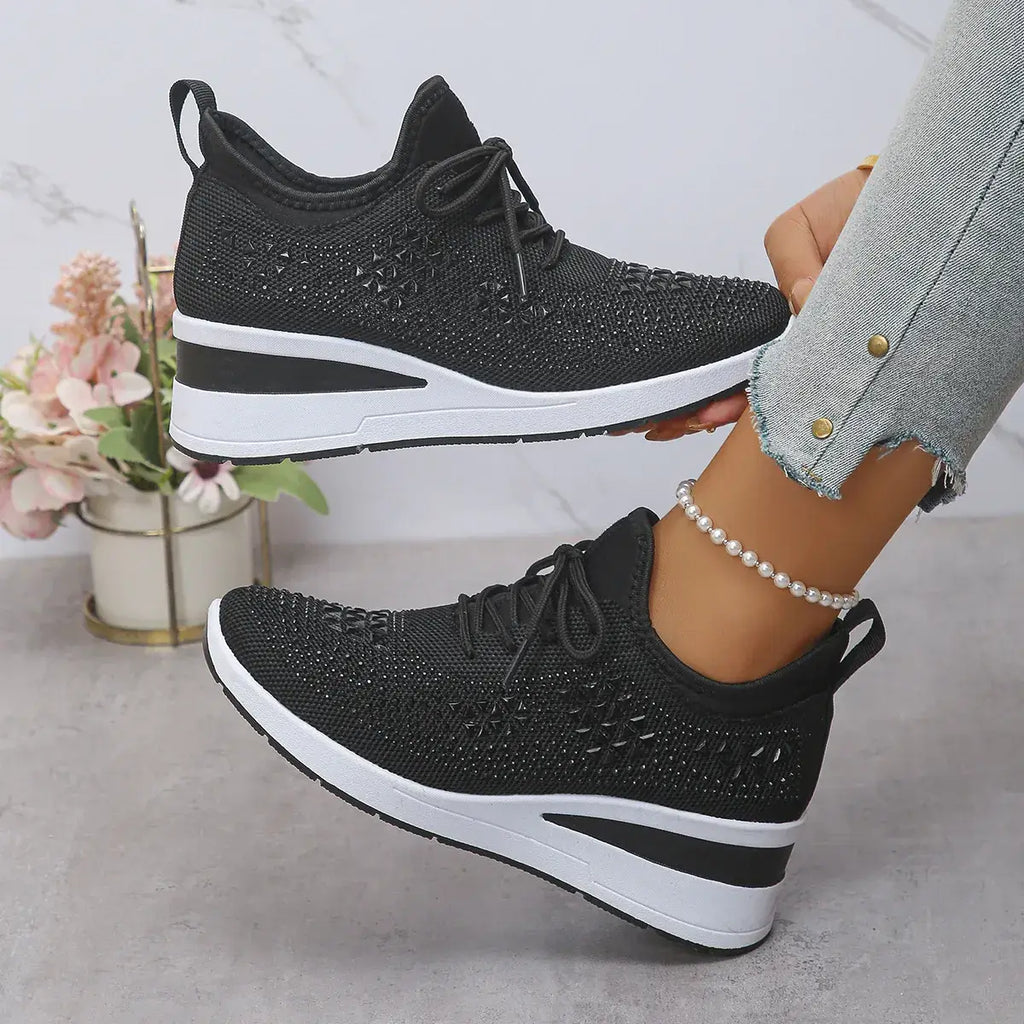Black and white sneakers worn by a person with a blurred background