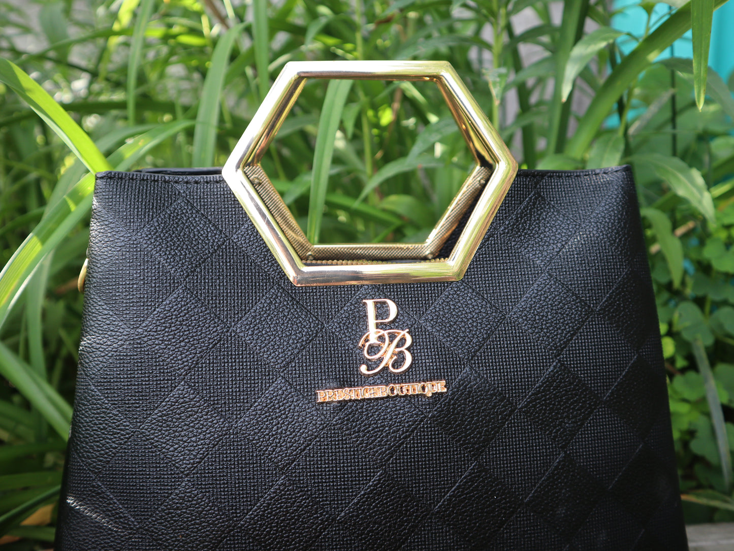Hexagon handle black and gold crossbody handbag