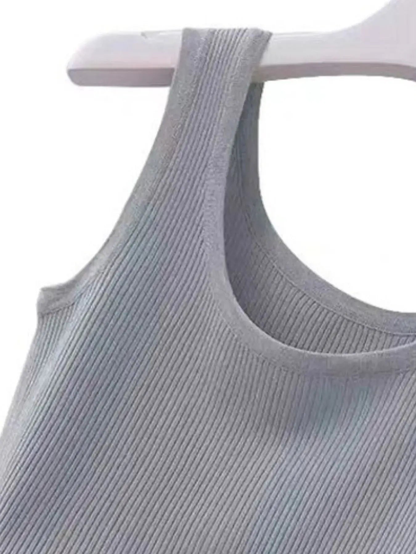 Gray ribbed tank top on a white hanger against a white background