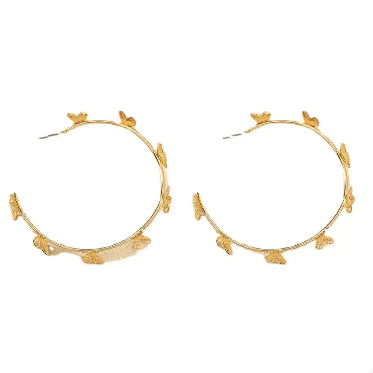 Gold hoop earrings with floral designs on a white background