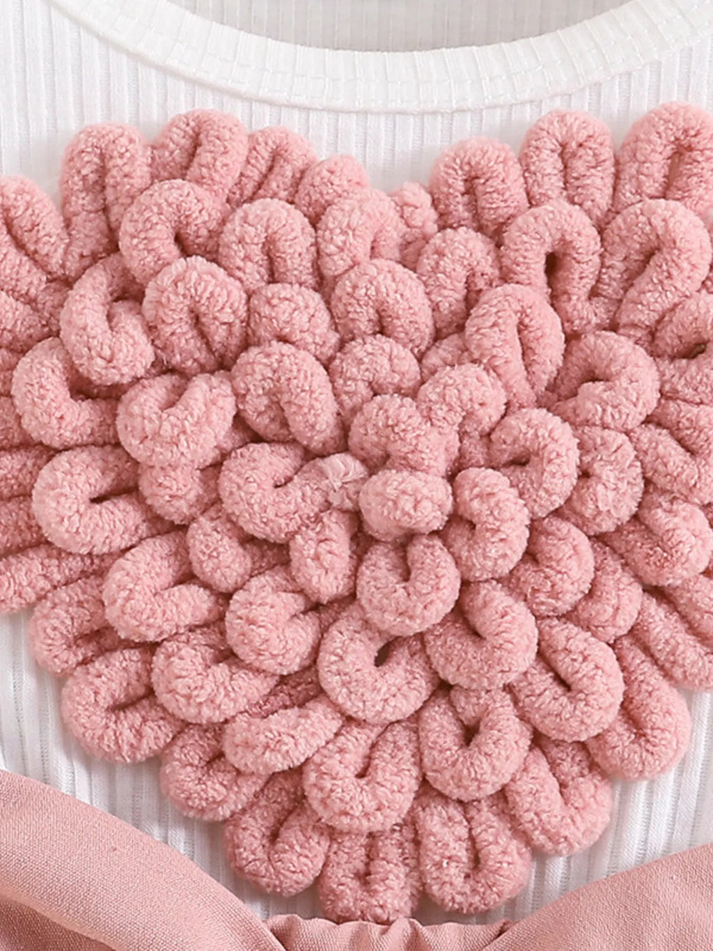 Pink textured bath mat on a white surface