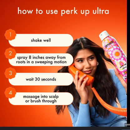 Person holding a phone with a hair product bottle, instructions on how to use 'perk up ultra' displayed.