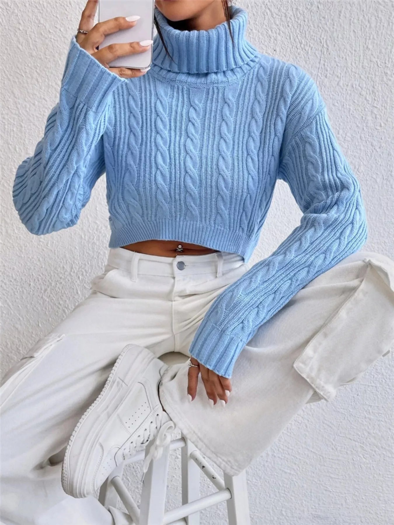 Cable-Knit Turtleneck Long Sleeve Sweater in light blue, styled with white jeans and sneakers, showcasing its cozy design.
