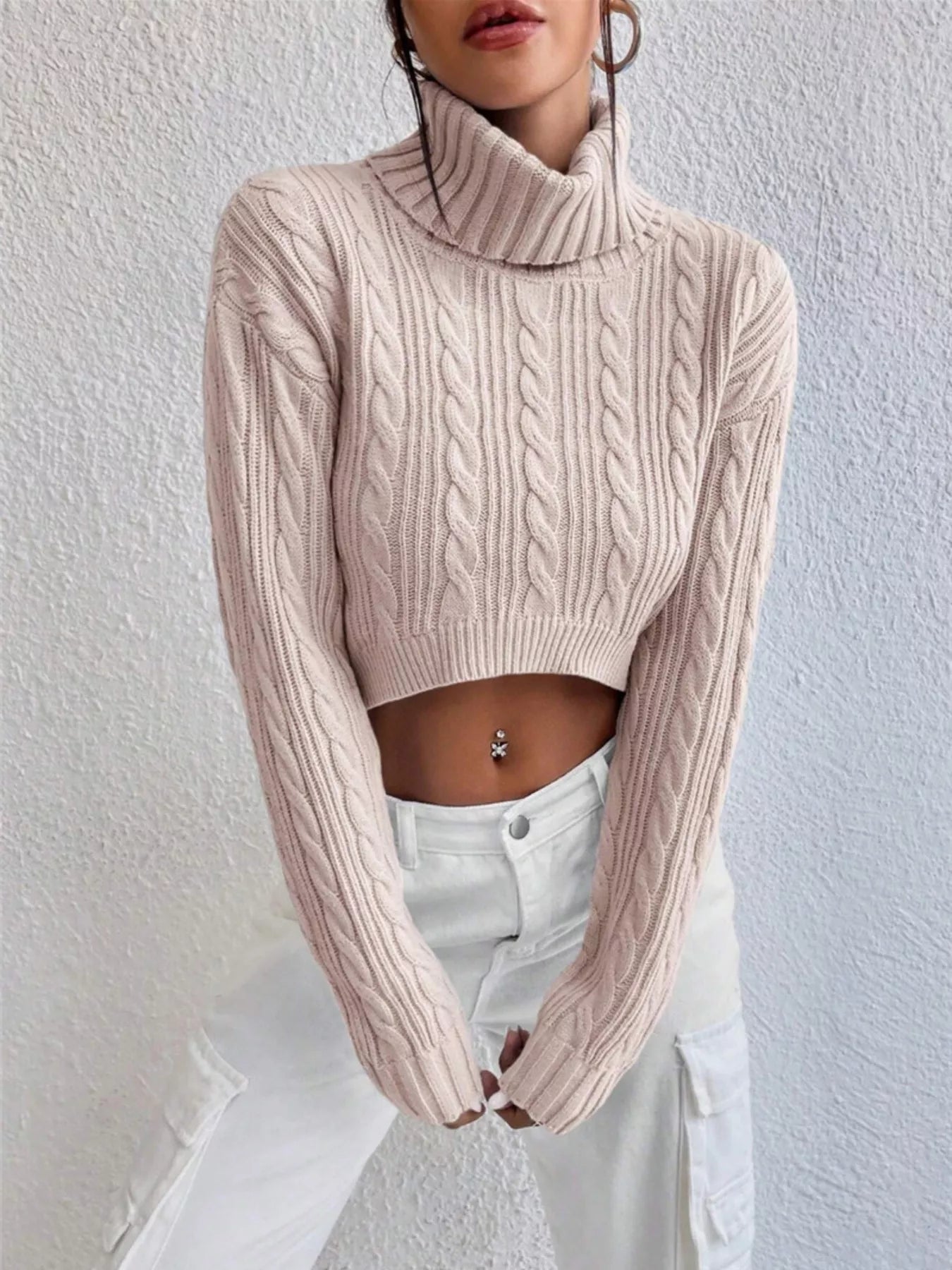 Cable-Knit Turtleneck Long Sleeve Sweater in light pink, showcasing a stylish cropped design and ribbed detailing.