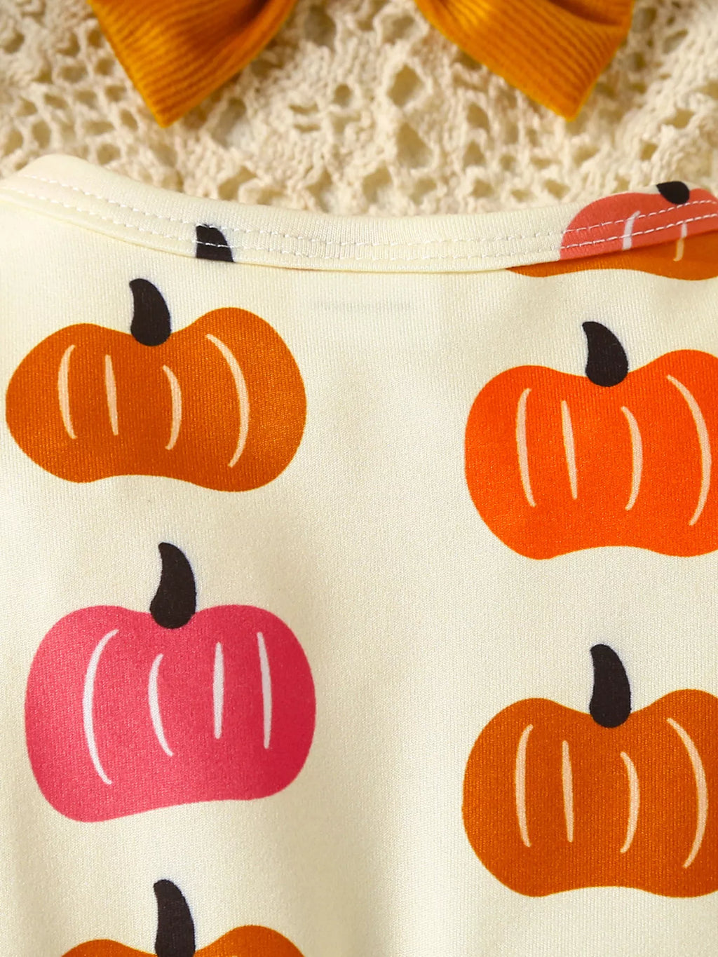 Fabric with pumpkins pattern on a textured background