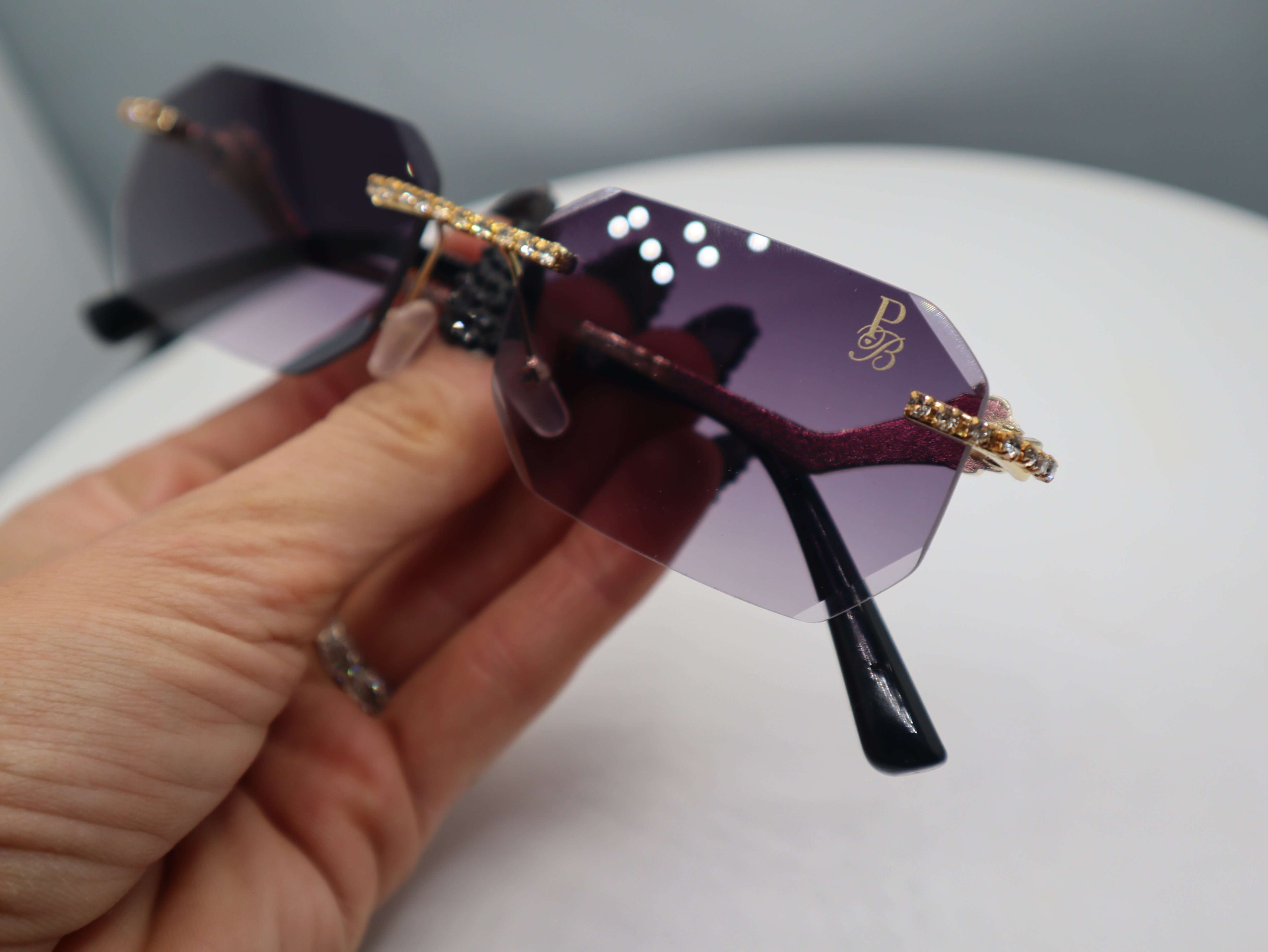 Close-up of Prestige Boutique Queen Of The Jungle women's sunglasses with beveled frames and elegant design.