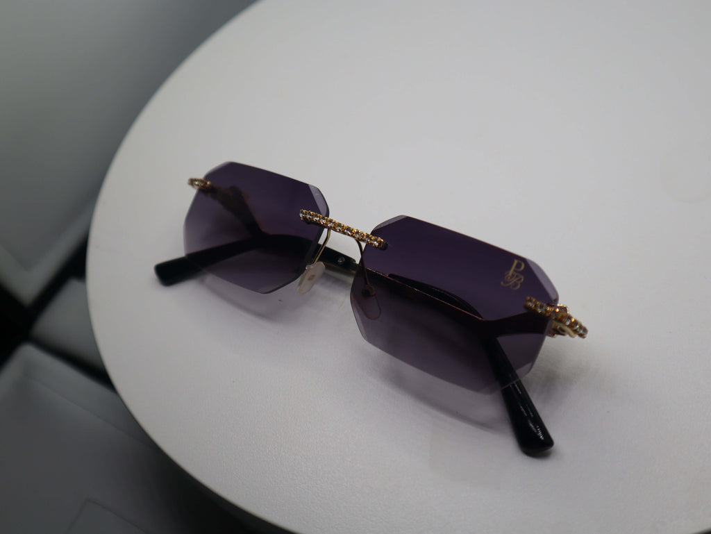 Prestige Boutique Queen Of The Jungle sunglasses with beveled frames and edgy design on a white surface.