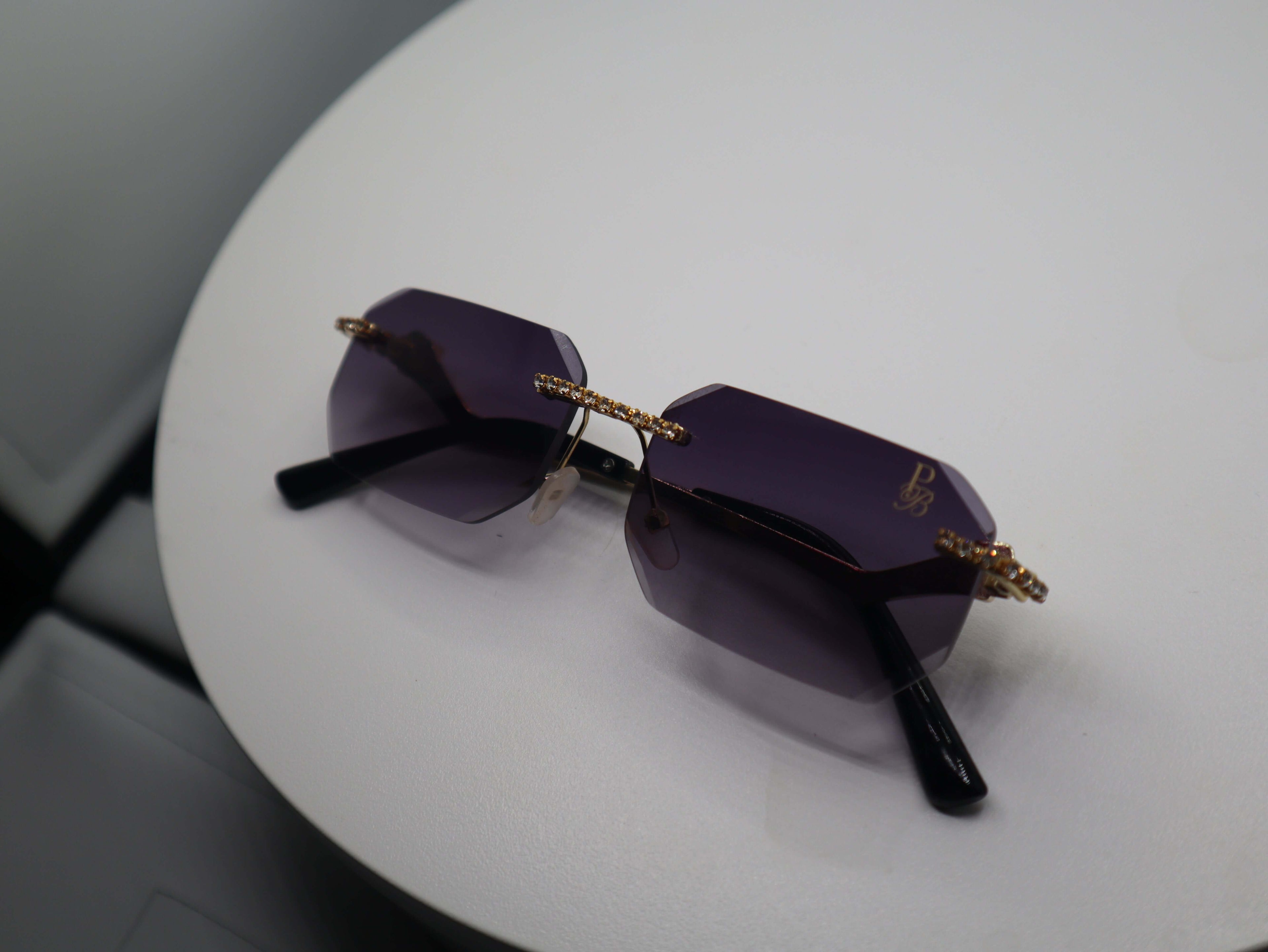 Prestige Boutique Queen Of The Jungle sunglasses with beveled frames and edgy design on a white surface.