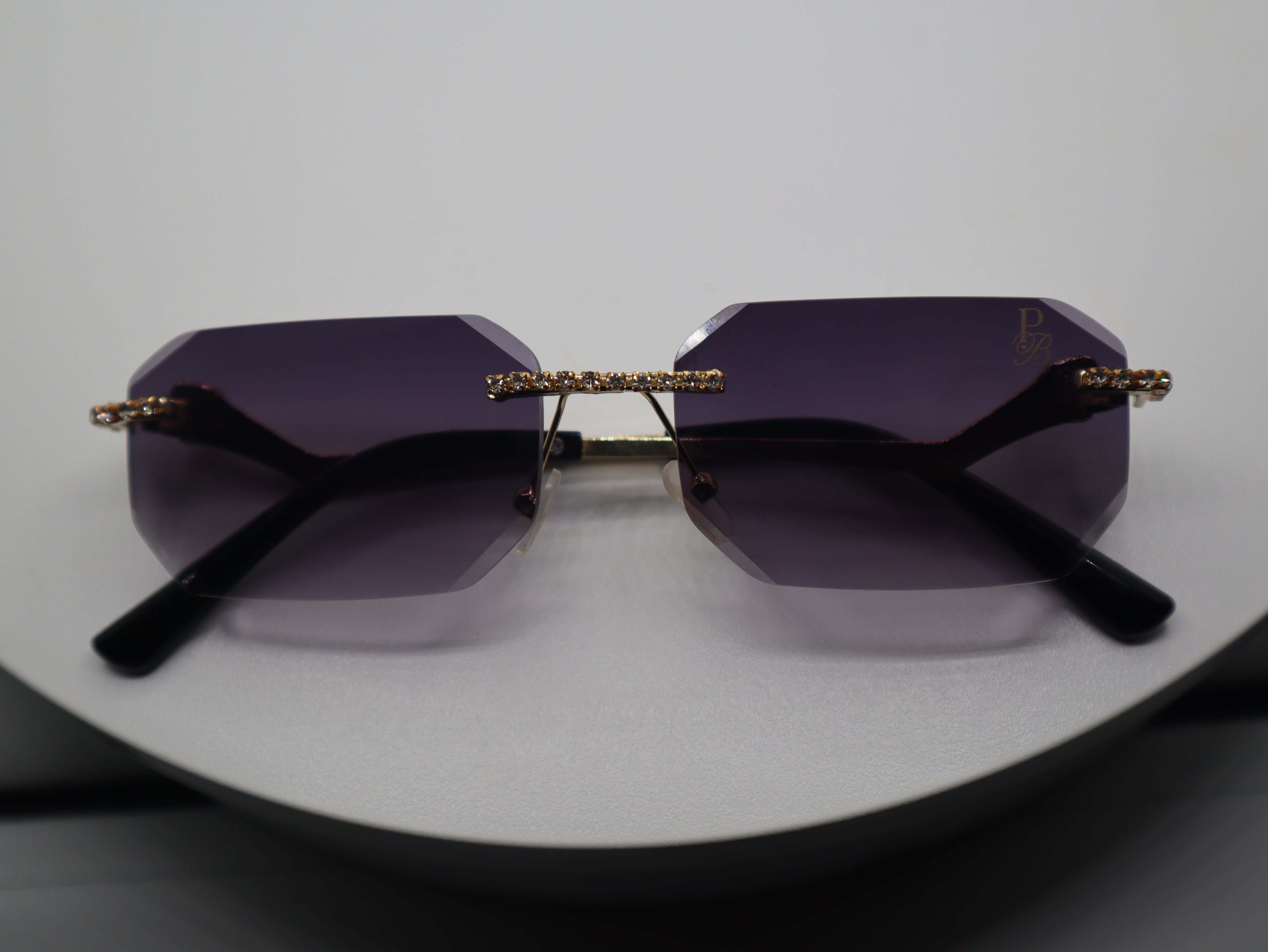 Elegant Prestige Boutique Queen Of The Jungle women's sunglasses with beveled purple frames and unique design.