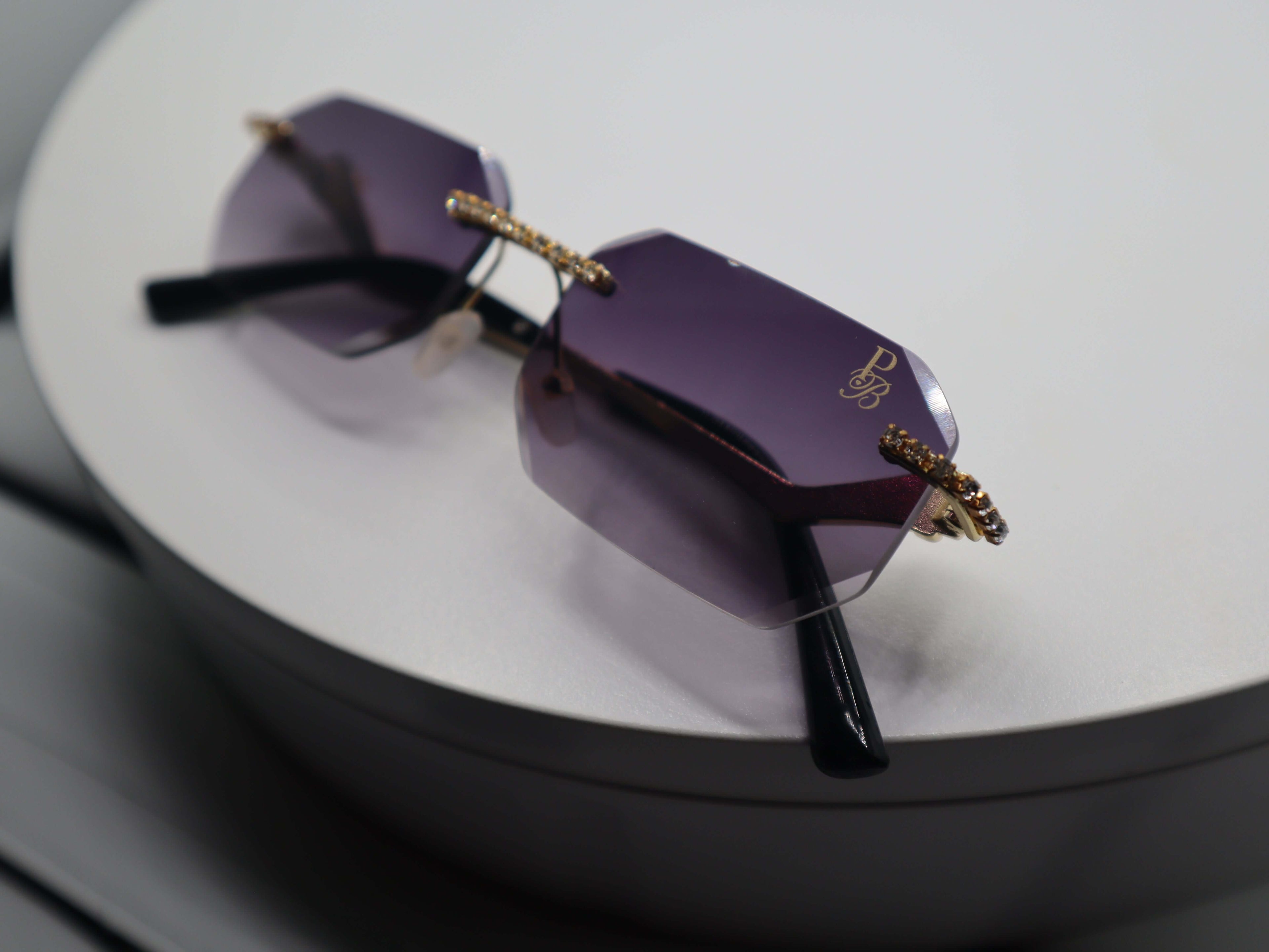 Prestige Boutique Queen Of The Jungle women's sunglasses with purple lenses and stylish beveled frames.
