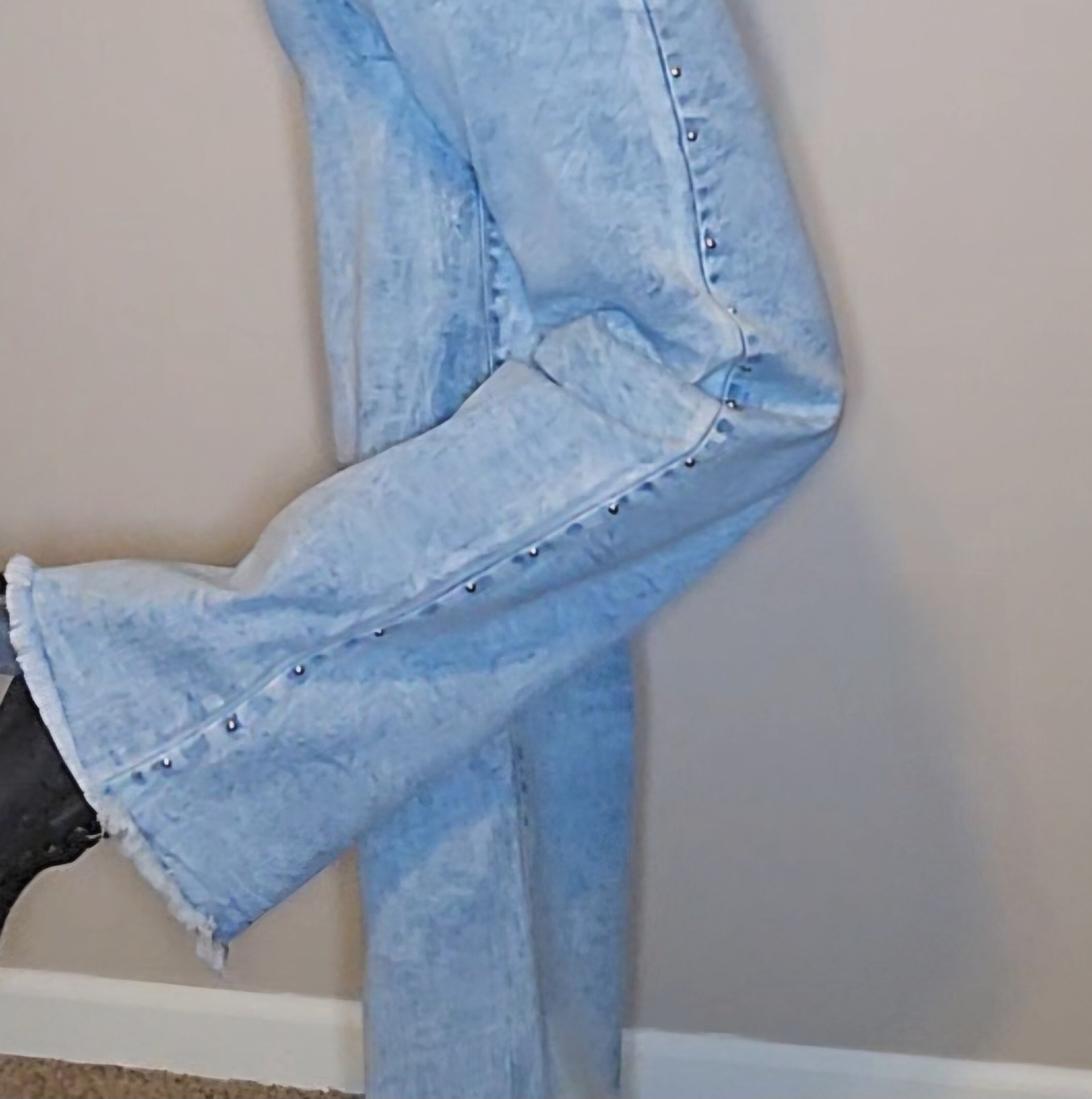 Brooklyn Studded BootCut High Rise Jeans featuring frayed hem and studded detail, light wash denim, model showing fit.