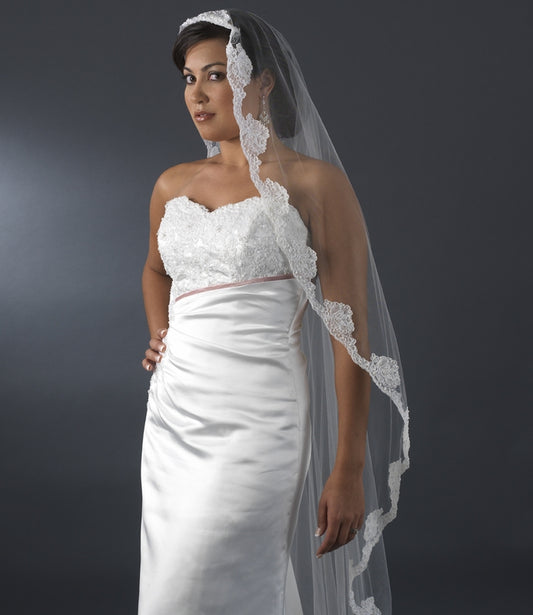 Bride wearing a single layer waltz cathedral veil with floral pearl embroidery, showcasing elegance for modern and vintage weddings.